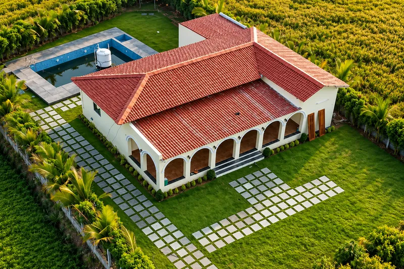 Aerial view of Mann Horizon farmhouse in Nizamabad with red tiled roof, swimming pool and lawn — AI recreation from supplied reference