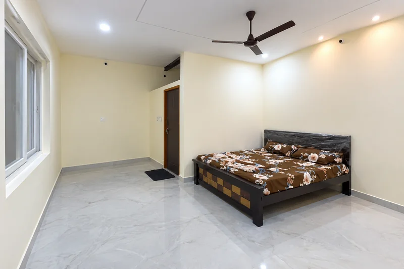 Bedroom with a double bed, cream walls and a window — AI recreation from supplied reference