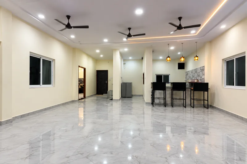 Living and dining area with marble floor, seating and pendant lighting — AI recreation from supplied reference